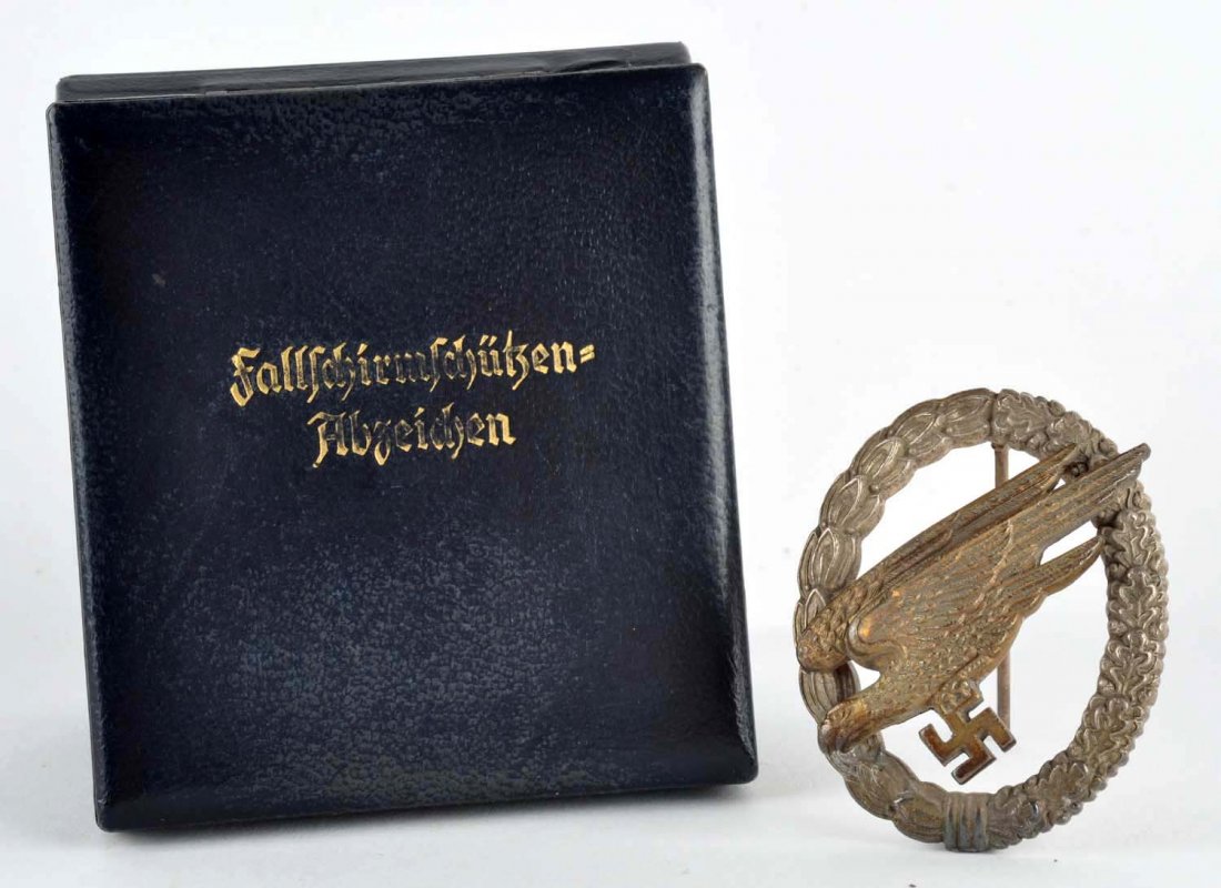Luftwaffe Paratrooper Badge.: This original badge comes in period correct box. Features flying eagle and swastika. Maker stamped on back. Dulling with age. Condition (Excellent).