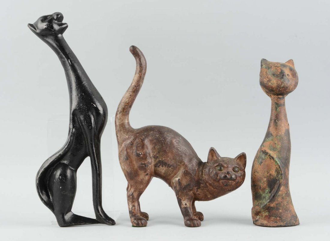 Lot of 3: Cast Iron Cat Doorstops & Plaque.: Hubley cat doorstop; Cast metal cat plaque; reproduction cat doorstop. Condition (Good). Size Largest: 13-1/2'' T.