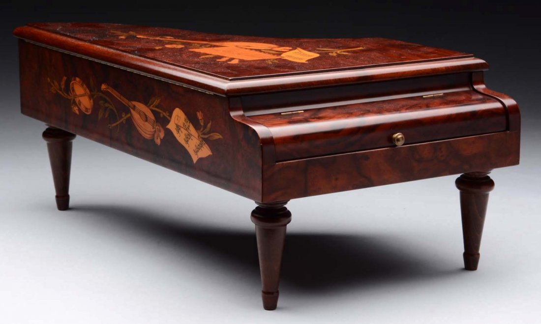 Reuge 3 Air Cylinder Music Box.: Burled walnut grand piano designed case. Seventy-two teeth. The tune sheet is present and is in operating condition at the time of inspection. Condition (Excellent). Size 16" x 6" x 8".