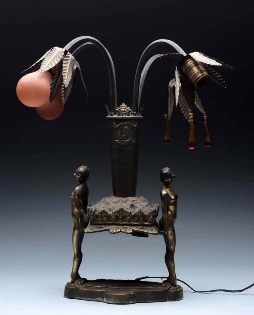Art Deco Style Lamp.: This lot is a decorative art deco style lamp, has been electrified with space for four light bulbs. Holding up the lamp, are two nude women that face outward. Hanging above the two figures are two are
