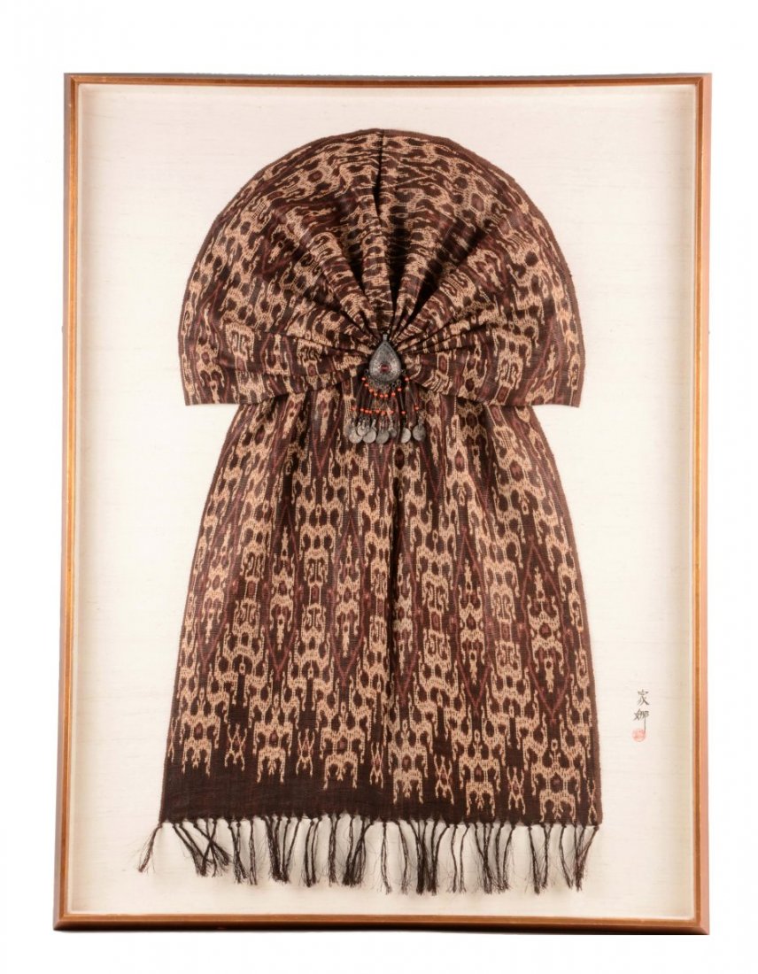 Indonesian Banana Leaf Fabric Decorative Hanging.: This Indonesian banana leaf fabric decorative piece is comprised of fabric displayed with an ornament in the center. The metal ornament in the center is teardrop shaped with a red stone in the center 