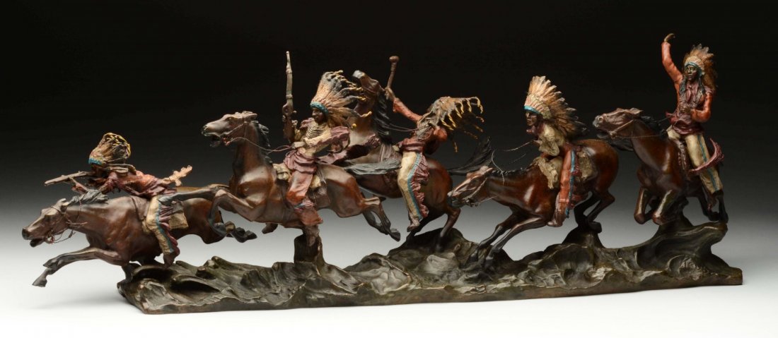 Native Americans Riding Horses By Carl Kauba.: This bronze statue by Carl Kauba depicts five Native Americans riding horses. Each figure is dressed in Native American garb with feathered headdresses. The weapons that each rider holds is either a g