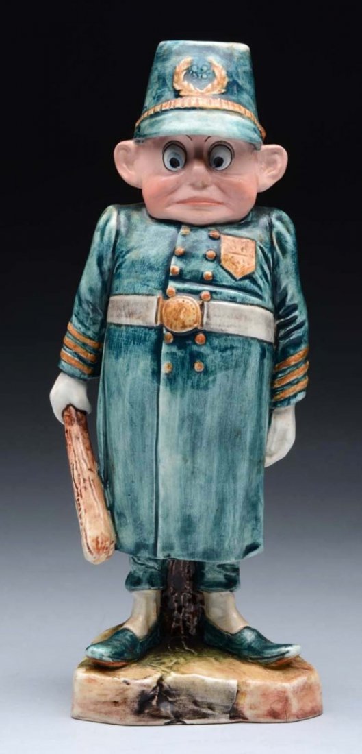 Brownie Palmer Cox Policeman.: This Majolica Palmer Cox Brownie Policeman is a candlestick. This policeman dons a blue uniform with a yellowish brown pocket on his left. The number 88 is stamped on the pocket, which can also be fou