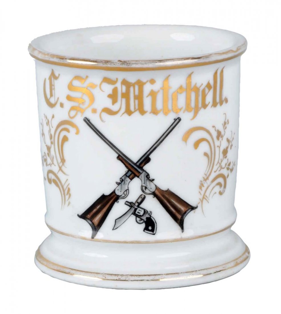Weapon Dealer's Shaving Mug.: Has the name J.S. Mitchell in gold gilt. Nice image of two shotguns, a pistol and a knife on the front. Condition (Excellent). Size 3 - 3/4" T.