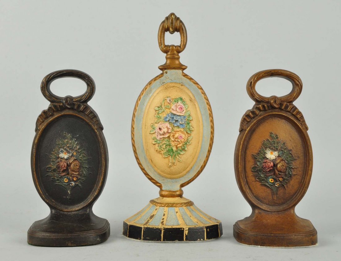 Lot of 3: Cast Iron Assorted Flower Doorstops. (1 of 1)