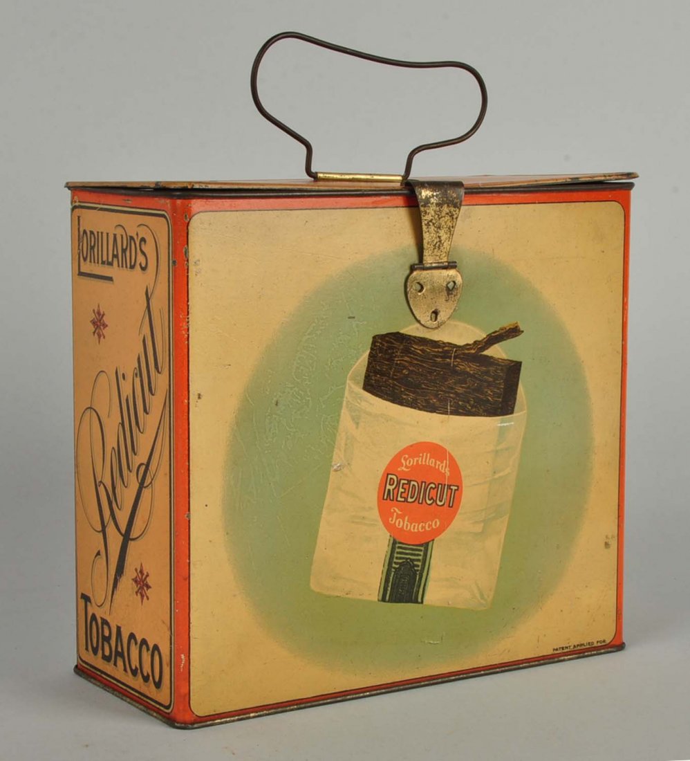 Lorillard’s Redicut Tobacco Tin.: This lot is of a Lorillard’s Redicut Tobacco tin. The slogan present on the tin is “Just break off a piece to fit.” Scratches, paint deficient areas and rusting are present. Some dents are prese