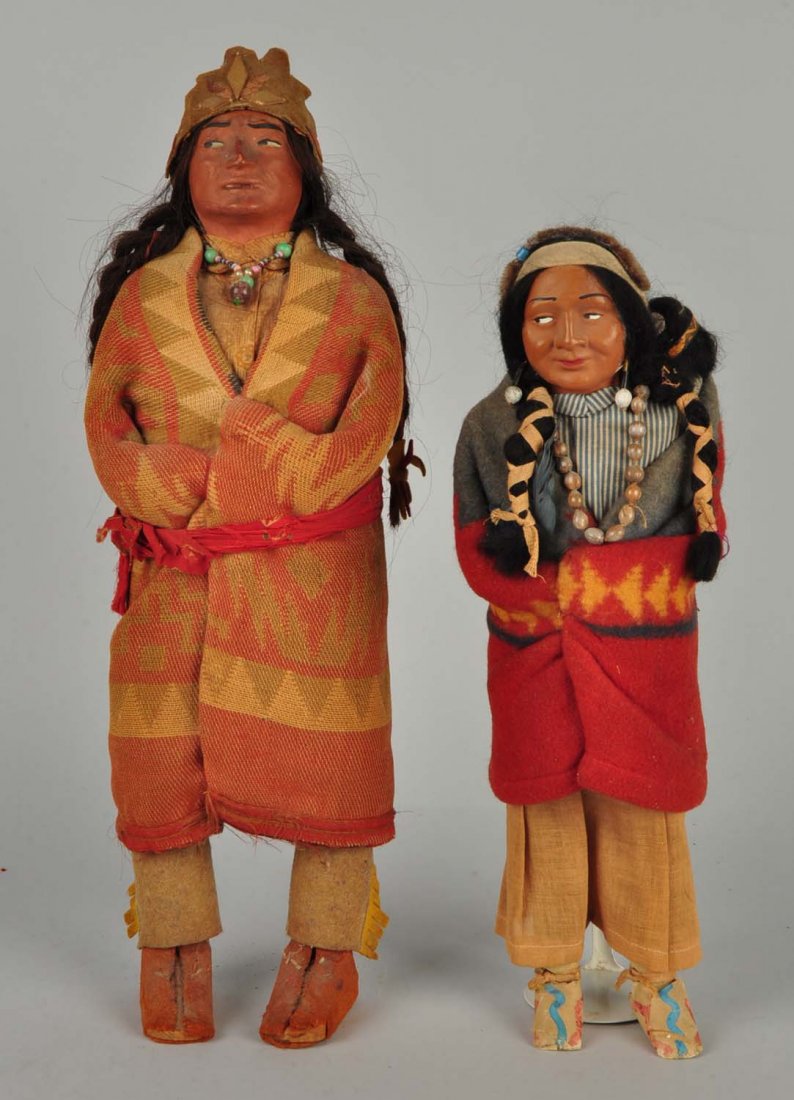 Lot Of 4: Vintage Skookum American Indian Dolls.: Both dolls have painted facial features, mohair wigs, cloth bodies wrapped in wool Indian blankets, wooden feet. The chief has an interesting usual headdress, some surface dirt and a small nose rub. H