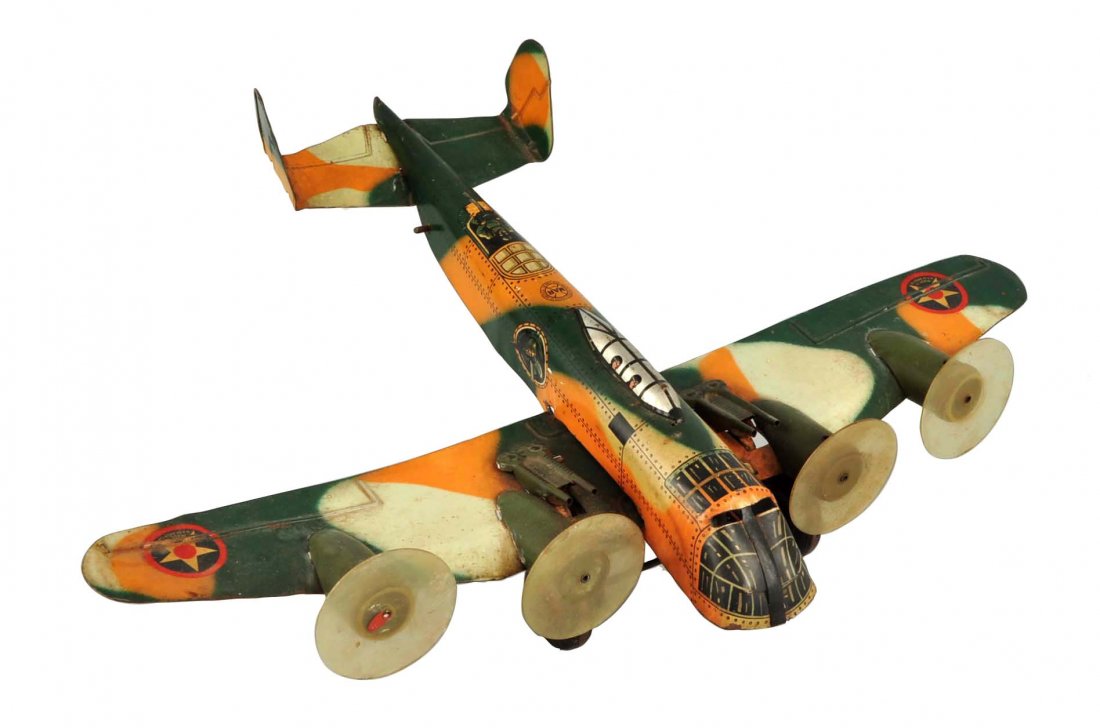Marx Tin Litho Wind Up Camouflage Airplane Toy.: Four original plastic props, gun are intact. Nice camouflage lithography. Some general overall scratching and wear. Could clean to a better grade. (Very Good). 13'' L.