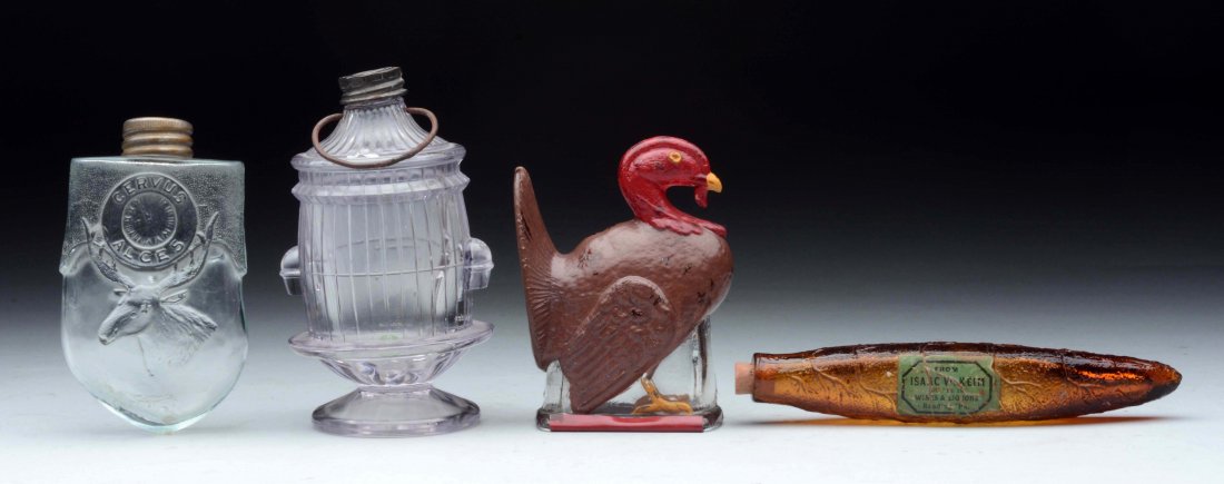 Lot of 4: Assorted Glass Candy Containers.: Birdcage - original closure and bail. Glass Elk's Tooth bottle - original closure. Turkey - repainted with original closure. Amber Cigar - with Isaac Keim label. (Very Good - Excellent). Largest: 5-1/