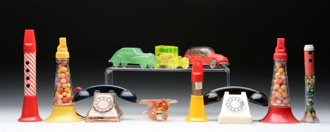 Lot Of 11: Assorted Horns and Other Candy Containers.: Red and yellow Millstein horns. All complete with original contents. Plastic and cardboard musical clarinet Stough's No 53 plastic and cardboard musical trumpet. Stough's 1953 horn. Boyd car with orig