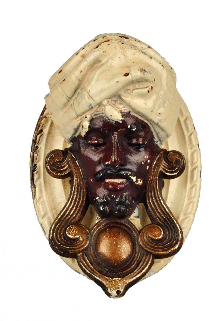 Cast Iron Genie Doorknocker.: Made by Judd Co. Depicts realistic looking genie in turban. Back plate repainted. (Very Good). 4-1/2'' L.
