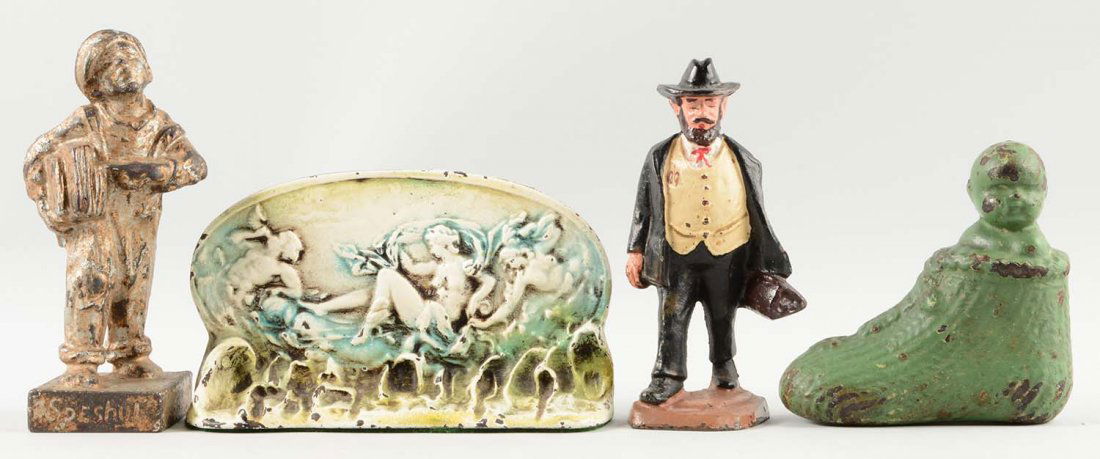 Lot of 4: Cast Iron Assorted Figural Doorstops.: Albany Foundry Co., John Wright, etc. Includes Doctor; Baby in Shoe; “Speshul”, Newspaper Boy; Cupids scene.