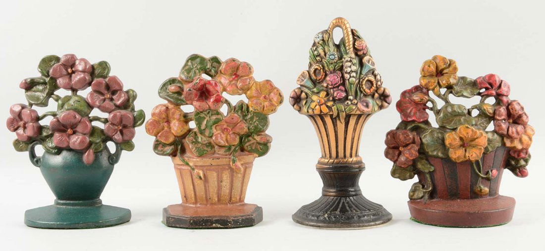 Lot of 4: Cast Iron Assorted Flower Doorstops. (1 of 1)
