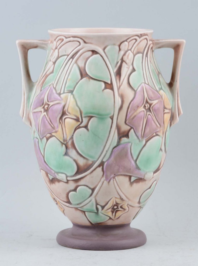 Roseville Morning Glory Vase: This lot is of a Roseville vase from the Morning Glory collection. This collection was first introduced in 1935 with a pattern consisting of open blossoms in white, yellow and lavender colors. the blo