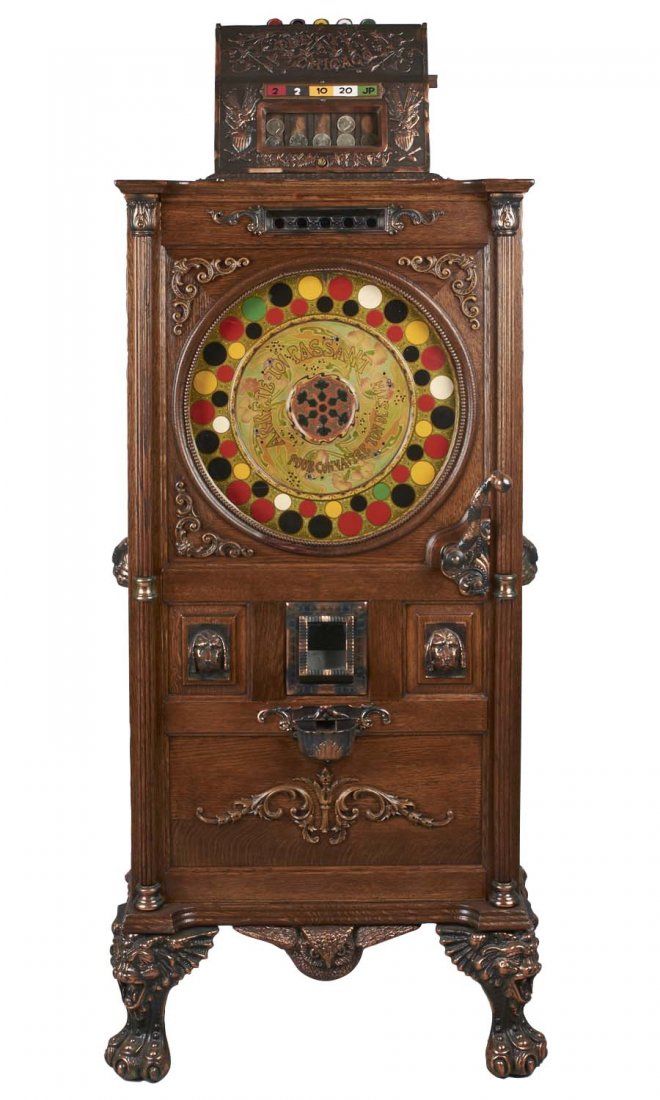 **50¢ Mills The Chicago Floor Wheel Upright Slot: Oak wood cabinet with hand carved details and cast metal furnishings including owl handles and gargoyle feet. This machine is housed in an older style cabinet with brass right handle and a new back do