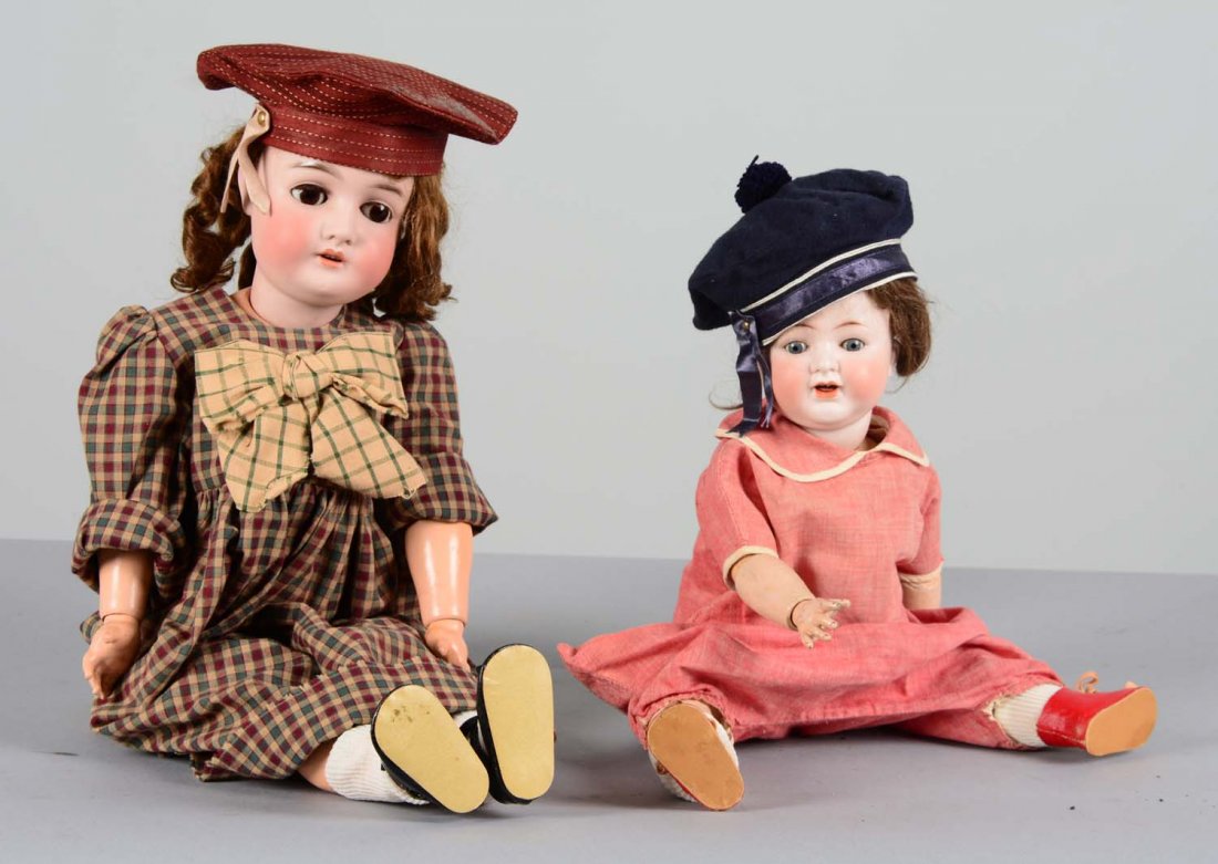 Lot Of 2: German Porcelain and Composite Dolls: Comprised of: 1- ABG or Alt, Beck, & Gottschalk, Germany baby or toddler doll with porcelain bisque socket head and jointed composite body. This doll has brown hair, blue glass sleeper eyes, and open 