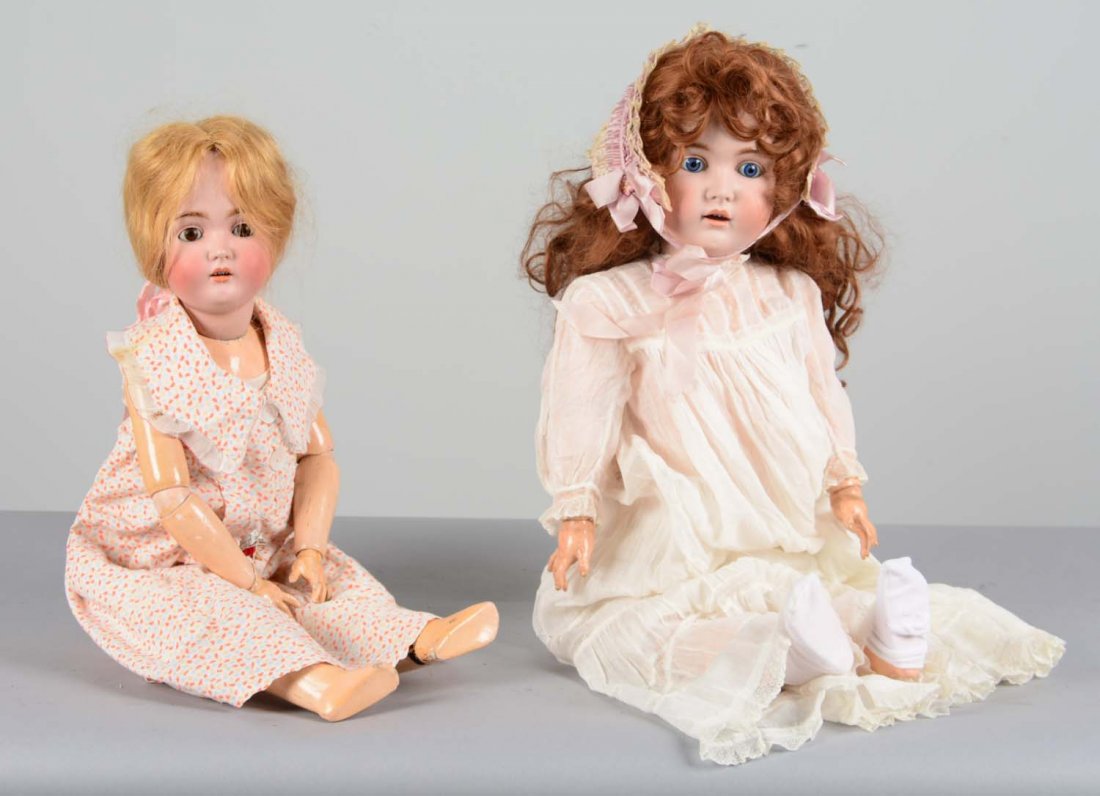 Lot Of 2: German Bisque and Composite Dolls: This lot is comprised of: 1- Kestner 171 doll. Porcelain bisque head with thick hand painted eyebrows, blue glass eyes, and open mouth with three teeth. Doll has long, curly, auburn hair and fully joi