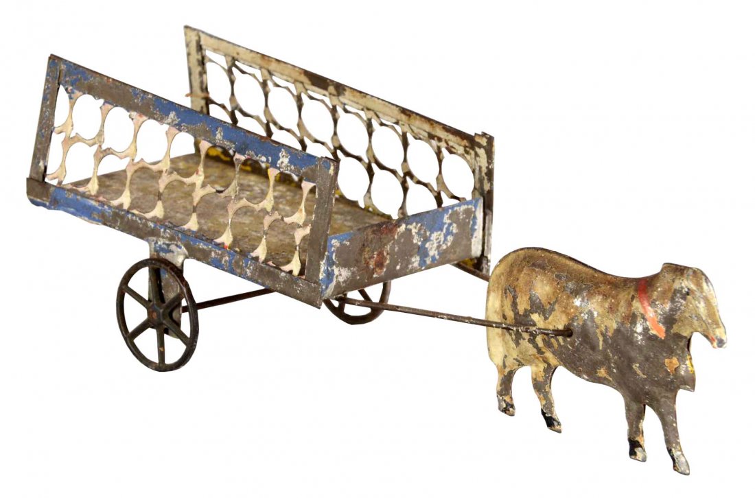 Ox And Cart Tin Toy: This tin toy features a metal ox and delicate die cut metal cart. This toy has severe paint flaking. (Fair). 10" L
