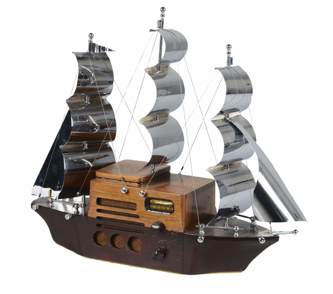 Majestic Melody Cruiser 1S49 Ship Radio: A charming novelty ship radio with wooden body and chromed metal sails. Circa 1941. (Good). 6" W. x 19" L. x 17" T.