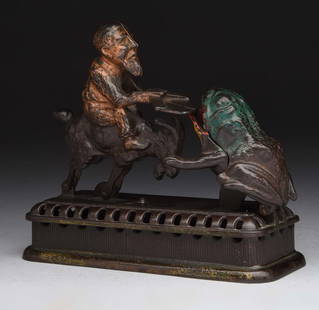 Cast Iron "Initiating 2nd Degree Mechanical Bank.: Mechanical novelty works bank. Set the goat back into locked position and place coin on the tray. Press the lever and the goat springs forward and the coin is deposited into the grogs mouth. (JY). (Ve