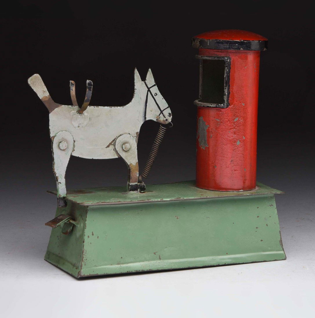 Sheet Metal Donkey & Silo Mechanical Bank.: Place a coin into the holder, which the sides are missing from this example. Then lock the donkey's leg into place and press the lever. The donkey will kick his back legs and the coin is knocked into