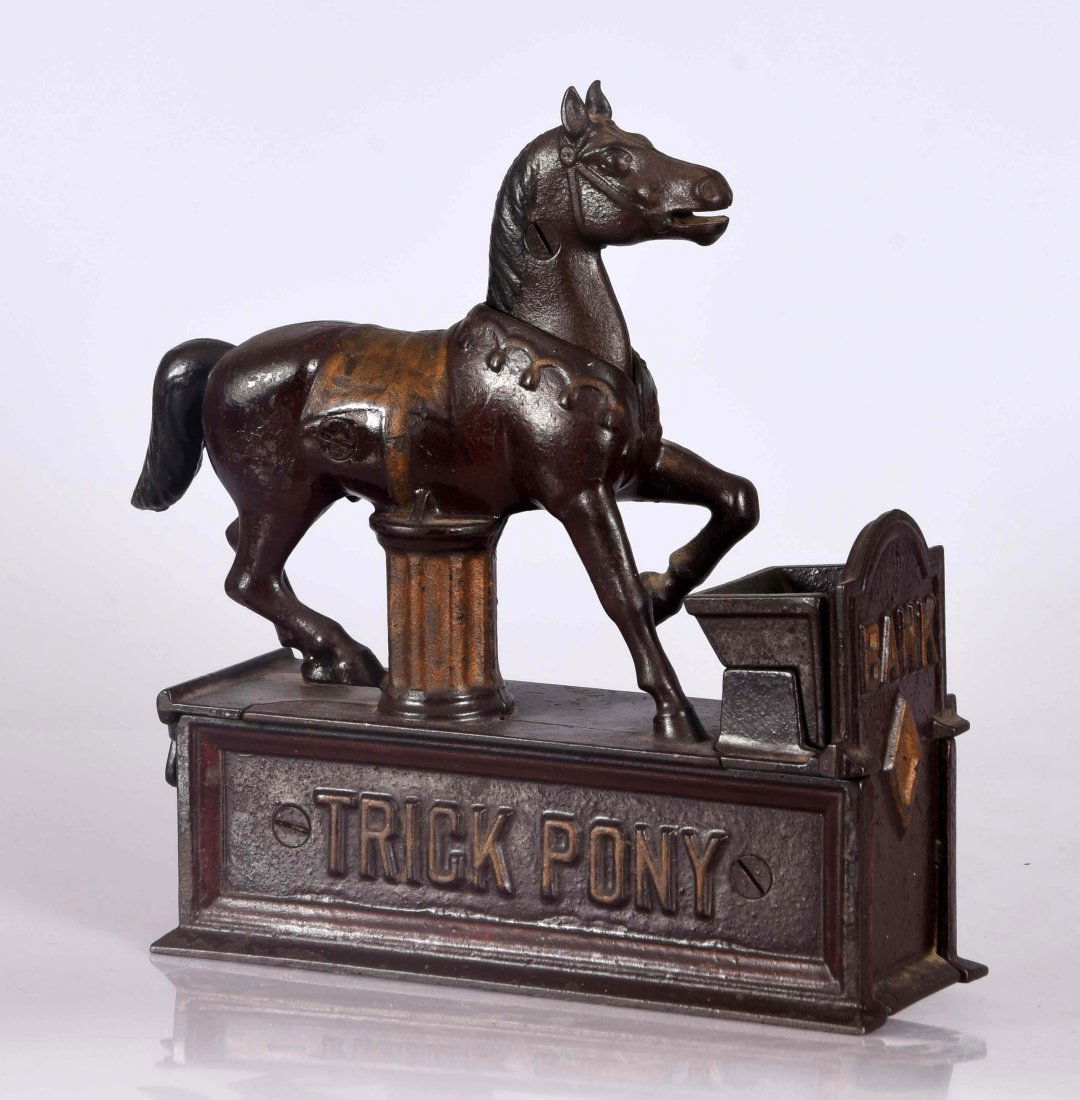 Shepard Hardware Trick Pony Cast Iron Mechanical Bank.: Place a coin in the horses mouth. Pull the lever and the horse lowers his head and deposits the coin in the trough. Areas of over paint overall. Original trap.