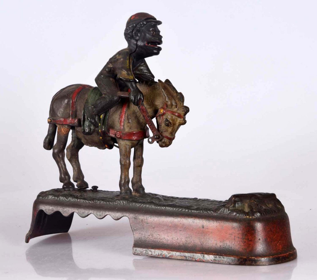 J. & E. Stevens I Always Did Spise a Mule Jockey Over: Place a coin in the figure's mouth and press the lever. The donkey kicks up and sends the jockey over to deposit the coin. Repair to rear legs, rough casting to areas of the mule. Base cracked on each