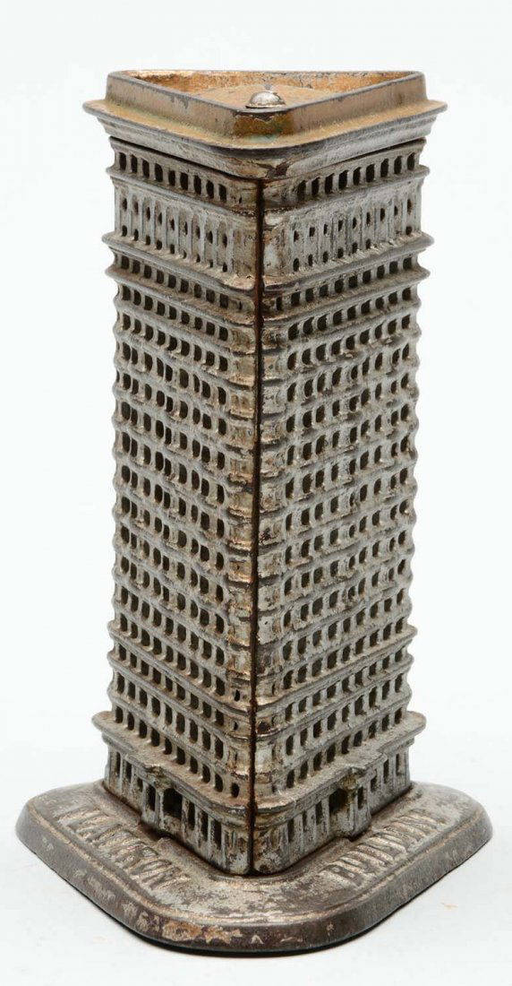 Cast Iron Flat Iron Building Still Bank.: Medium size. Missing trap. Some paint loss to top by coin slot. Overall general wear. (Very Good). 6'' T.