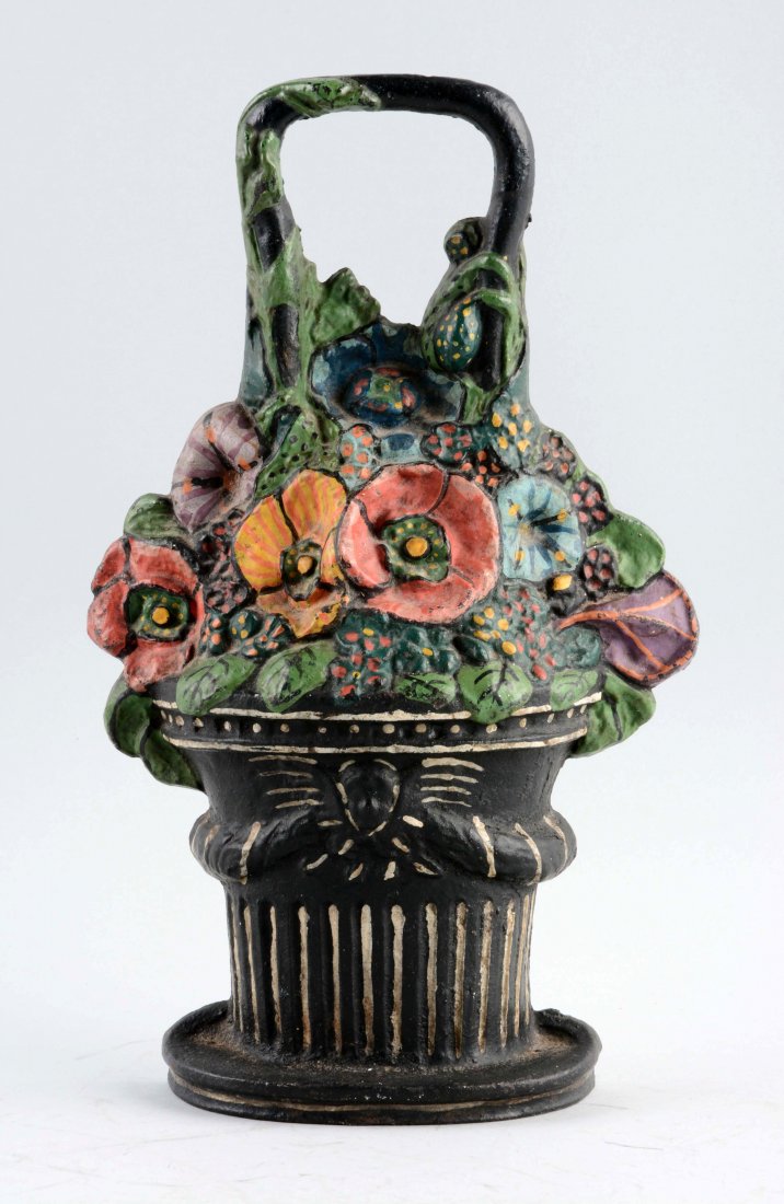 Cast Iron Pansies in Basket Doorstop.: Depicts old fashion mixed pansies in basket with angel’s face on basket. Book Example. (Excellent). 11 - 3/4" T.