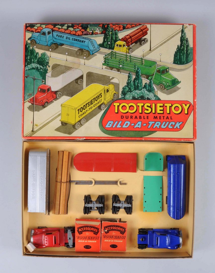 Tootsietoy No. 7600 Bild-A-Truck Toy Set.: Circa early 1950's. Set includes: Late 1940's Mack cab in blue, Tanker body, Stake body, two sets of rear wheels, logs for the log truck, top for the Van Line's truck, red cab, all are in near mint co
