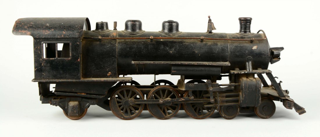 Pressed Steel Buddy L Steam Locomotive.: Complete and all original, except that there is a brass plate riveted to one side. Corrosion on the wheels, pilot is slightly bent, scratches and paint chips and the Buddy L insignia on the front is m