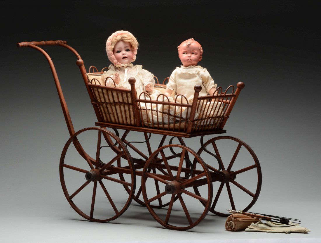 Lot Of 2: Baby Dolls With Wooden Carriage.: Included are a bisque head baby with head incised "K&R Simon & Halbig 116/A36". She has blue glass sleep eyes with painted upper and lower lashes, an open mouth with two upper teeth and separately mol