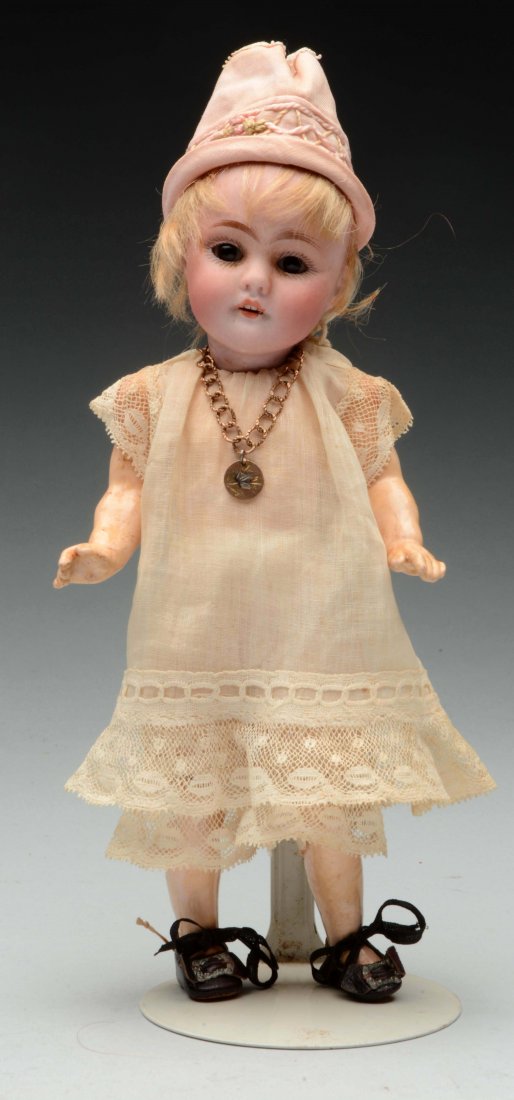 Small 143 Kestner Doll.: Adorable small doll with head incised "Made in Germany 143" with brown glass sleep eyes, open mouth with upper teeth and blonde mohair wig. On a fully jointed composition body with straight arms and w