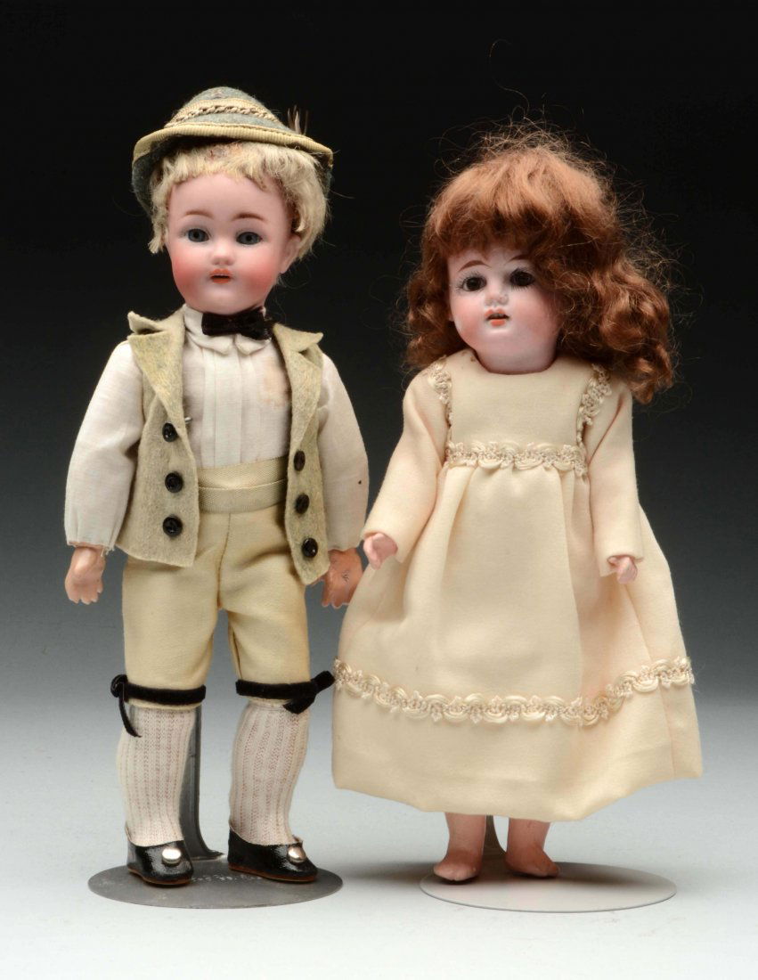 Lot Of 2: German Bisque Dolls.: A boy with bisque socket head incised Simon & Halbig 1079 with blue sleeping eyes, delicately painted facial features, open mouth with upper teeth, original mohair wig (a bit sparse) on his original f