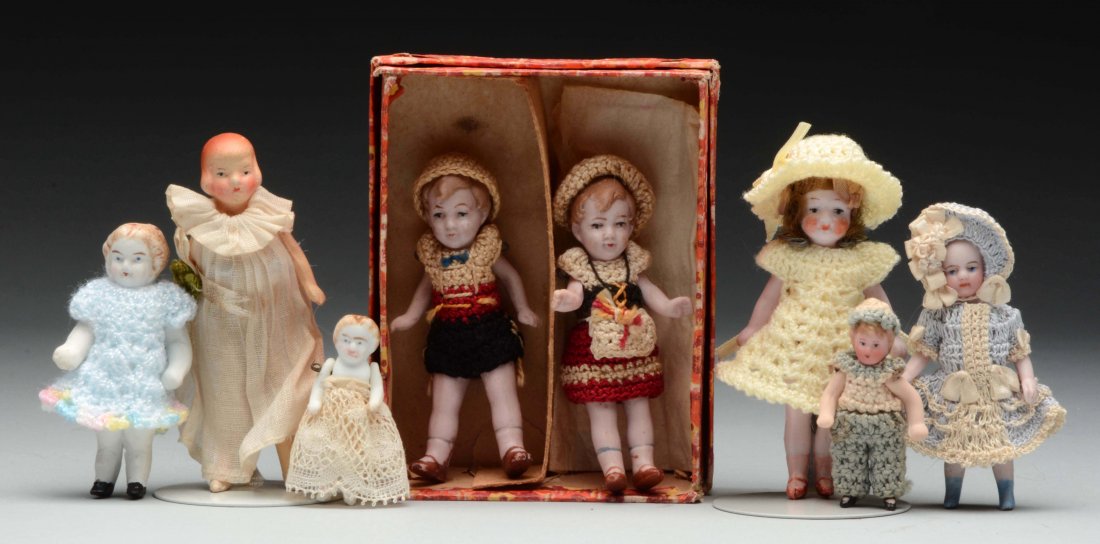 Lot Of 8: Miniature Dolls.: Pair of pink bisque boy and girl with molded blonde hair and painted features in original box wearing original matching crocheted outfits; a 1920's painted bisque lady with molded hair and original dr