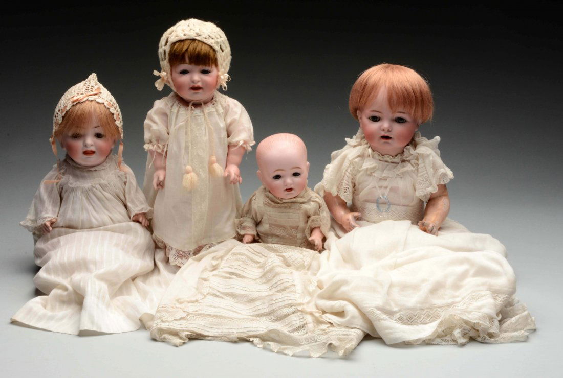 Lot Of 4: German Bisque Head Baby Dolls.: The largest in the group is incised "K&R Simon & Halbig 121 36" and has blue glass sleep eyes, and open mouth with two upper teeth, and is on the original five piece composition baby body. Next is a H