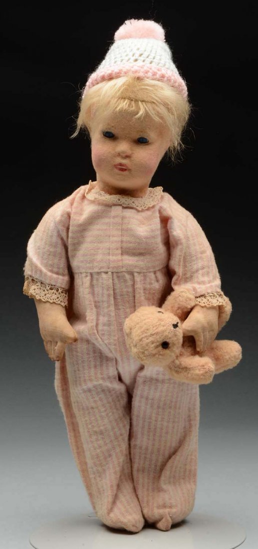 Steiff Child Doll With Glass Eyes.: Felt doll with swivel head and cloth body with joints at shoulders and diagonal joints at hips. Wears a pink and white striped cotton pajamas with crocheted hat with pom-pom on top. Sewn to his left w