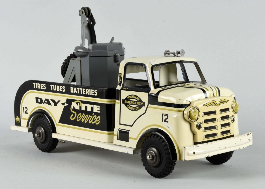 Marx Highway Emergency Service Tow Truck.: Very colorful. Battery operated back lights, includes the tools. Missing the hook for the boom. Minor scratching throughout and some paint loss to the back bumper area and bed. Lithography is quite ni