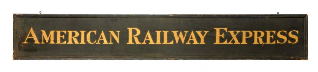 American Railway Express Wooden Trade Sign.: This early sign has an original sand painted surface and wooden frame. Retains its original shipping tag on the back of the sign. It is in very good condition with minor wear and one stress crack on t
