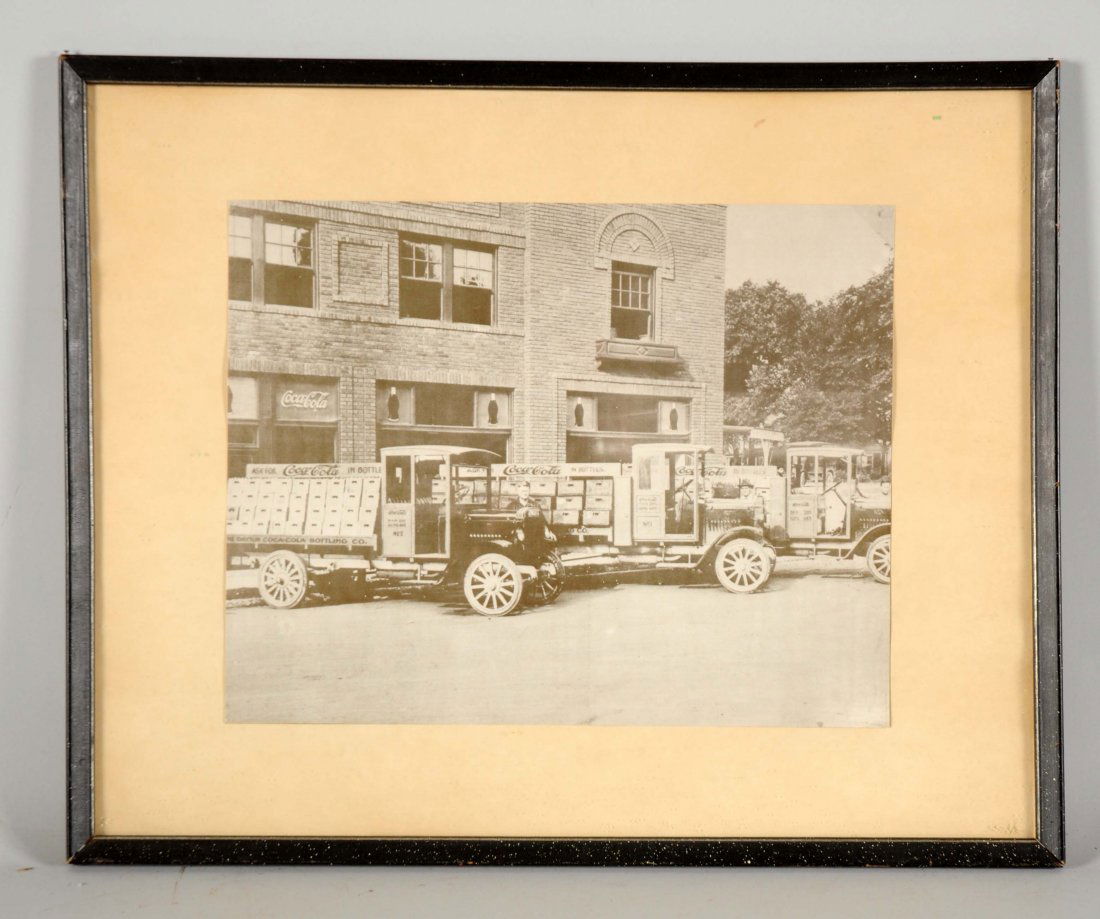 Coca-Cola Bottling Plant Oversized Contemporary Photo.: This photo is framed behind glass. It shows three Coca-Cola delivery trucks outside of a Coca-Cola bottling plant. There is some soiling and minor wear. (Very Good). Frame : 21" x 17".