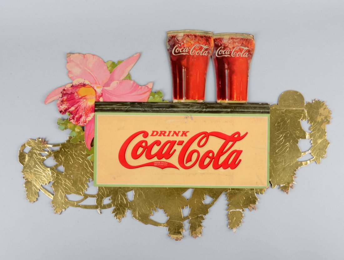 Coca-Cola Diecut Advertising Sign.: Sign shows two Coca-Cola glasses. Areas of missing cardboard and foil, peeling, soiling and fold marks. (Very Good). 29-1/2'' x 20''.
