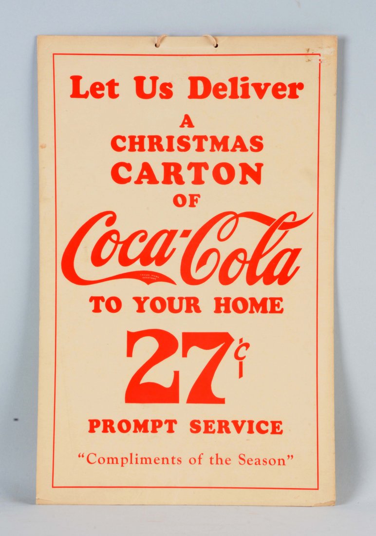 Cardboard Coca - Cola Delivery Service Advertising: This sign is advertising a delivery service for a carton of Coca-Cola during the Christmas Season. Has some sticker residue on the top right, damaged bottom corner and scattered edge wear with some li
