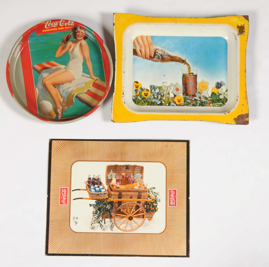 Lot Of 3: Coca - Cola Tin Sign & Trays.: The tin sign has some writing in the left area of the field and a few areas of paint chipping. The tray that shows the bottle of Coca-Cola on it has moderate soiling and paint loss to the edges and bo