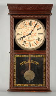 Coca - Cola Advertising Regulator Clock.: Clock has a paper label face. It is stamped "Made by the E. Ingraham Company, Bristol, Connecticut". There is moderate wear to the face and missing glass to the top. The wood has a nice patina through