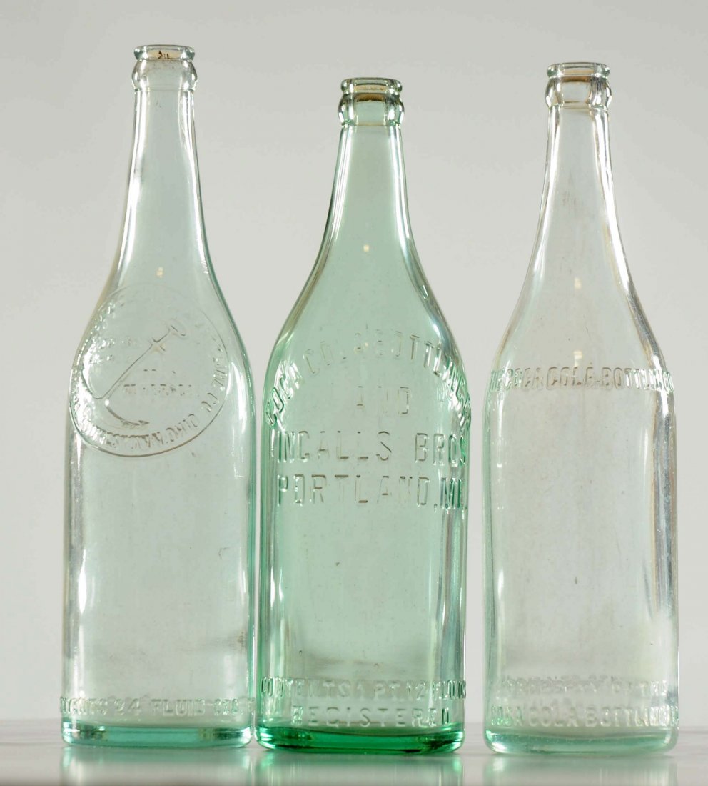 Lot Of 3: Over Sized Coca - Cola Bottles.: One of the bottles is from Youngstown, Ohio, another from Chicago, Illinois and the last is from Portland, Maine. Minor soiling inside. No chips to the lid or base of any of the bottles. (Very Good).