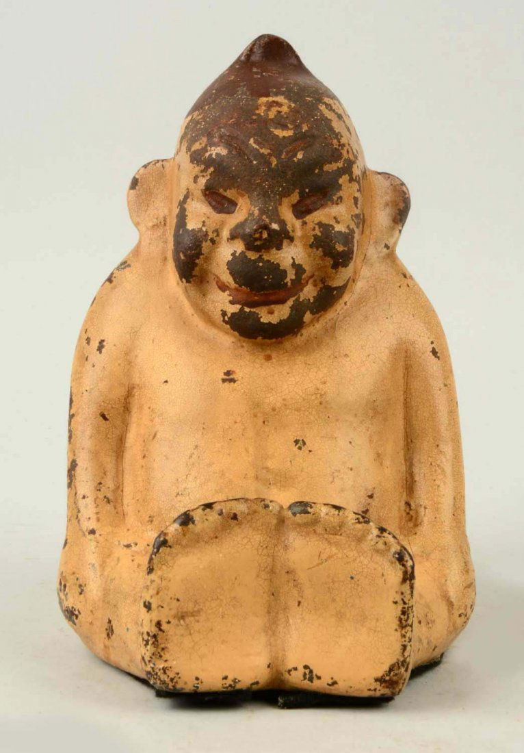 Cast Iron Billiken Doorstop.: Depicts full-figure sitting Billiken. (Good). 7 - 1/2" T.