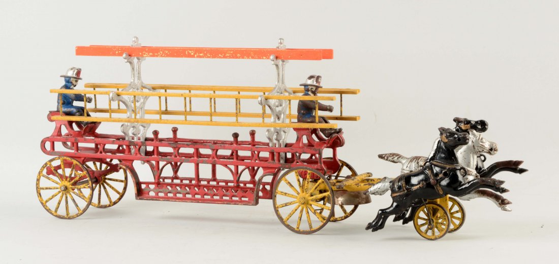 Cast Iron Kenton Horse Drawn Fire Ladder Truck.: Pulled by three horses. Horses are articulated. Includes two original firemen and three wooden ladders. Metal stanchions that hold ladders are replacements. Some paint loss and wear. (Very Good). 23" 