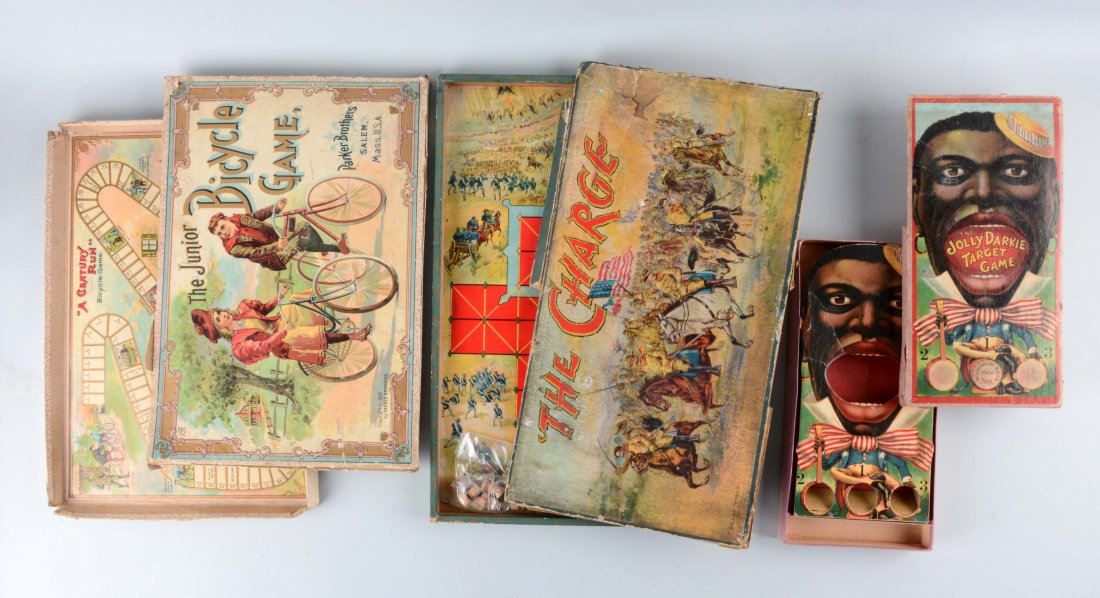 Lot Of 3: Board Games.: Lot includes: The Charge by Clark & Sowdon with losses to the side and splits; The Junior Bicycle Game by Parker Brothers, dated 1897 with cardboard losses and splits; and The Jolly Darkie Target Game