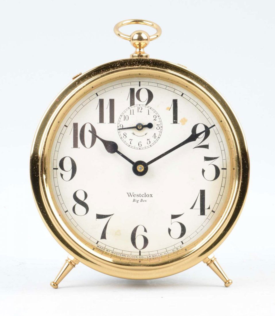 Gold Westclox "Big Ben" Clock: This lot is of a Gold Westclox "Big Ben" Clock. The clock has small feet at the bottom to stand it up and a small circular handle at the top. There is a second hand clock face as well. The clock has a