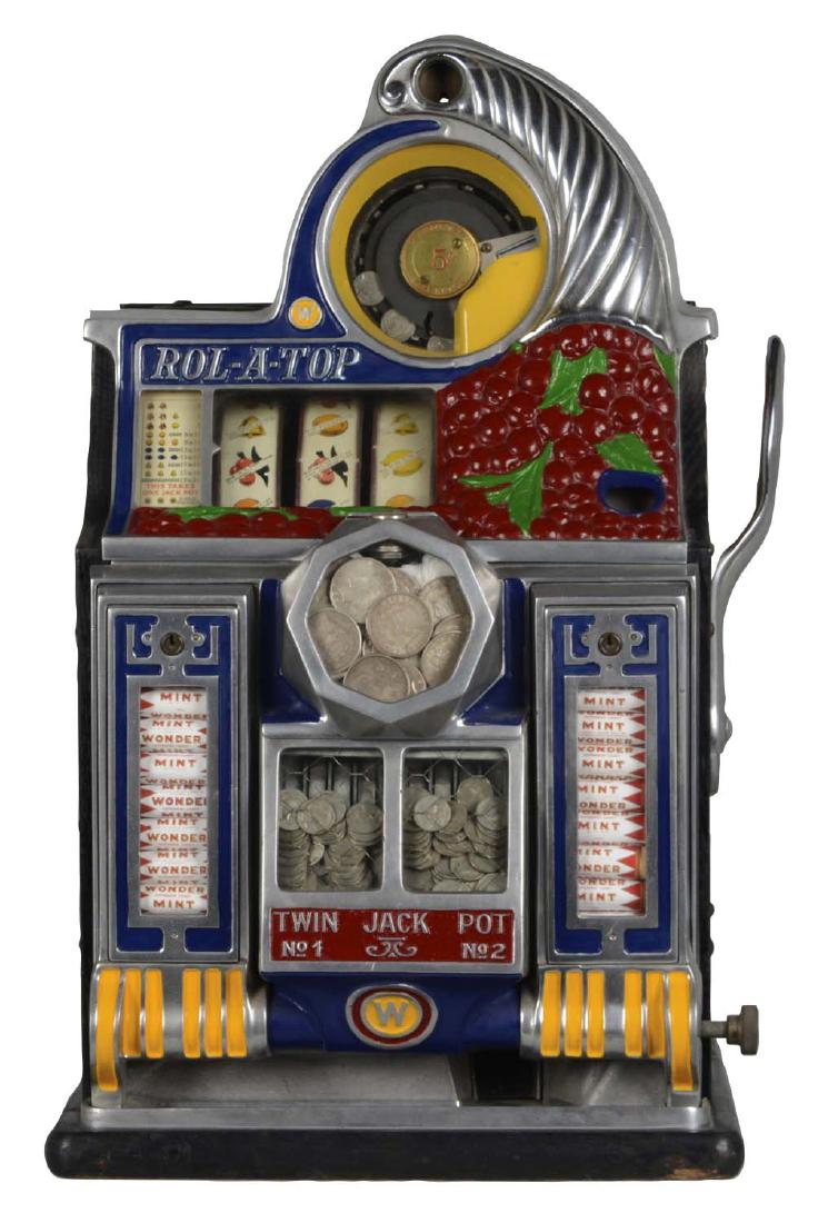 **5¢ Watling Rol-A-Top Vender Twin Jackpot Cherry Slot: Watling produced this beautiful machine in 1936. It is in beautiful, unrestored condition showing older paint and original reel strips and awards card. Has some damage to the back bonnet, a cracked ba
